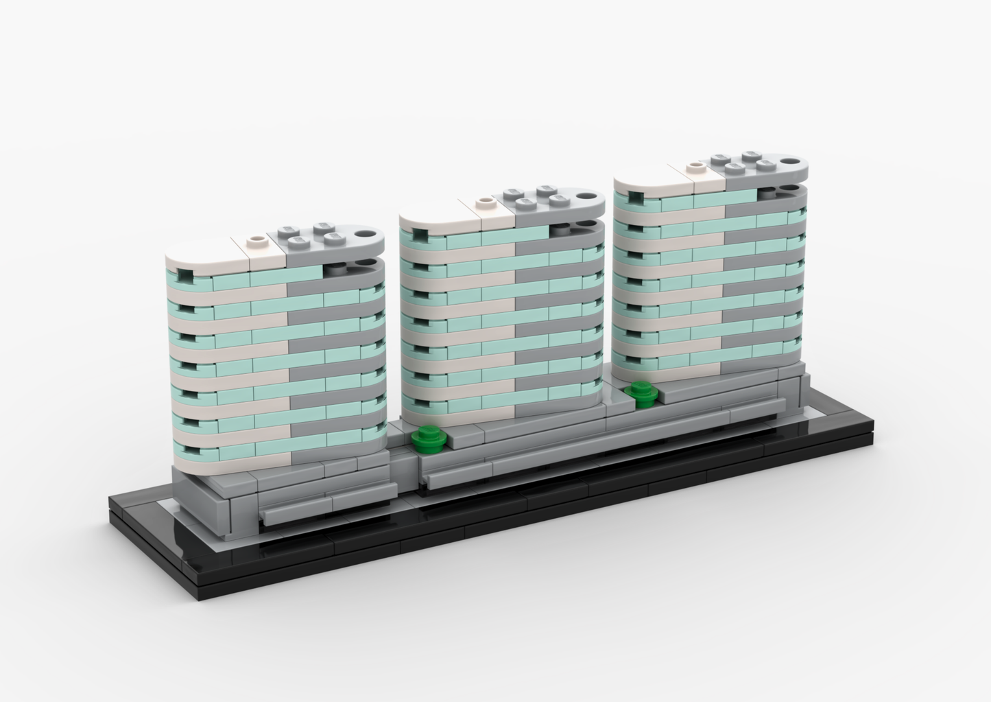 Model of three modern buildings made from interlocking bricks on a white background.