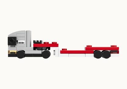 Toy truck model made from interlocking bricks on a white background