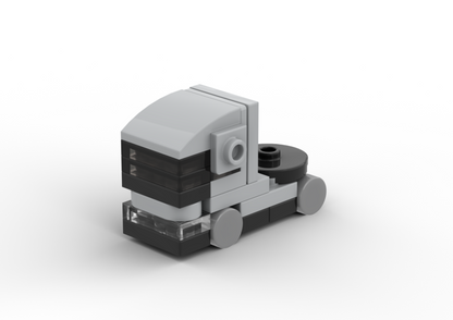 Small model of a truck made from interlocking bricks on a white background