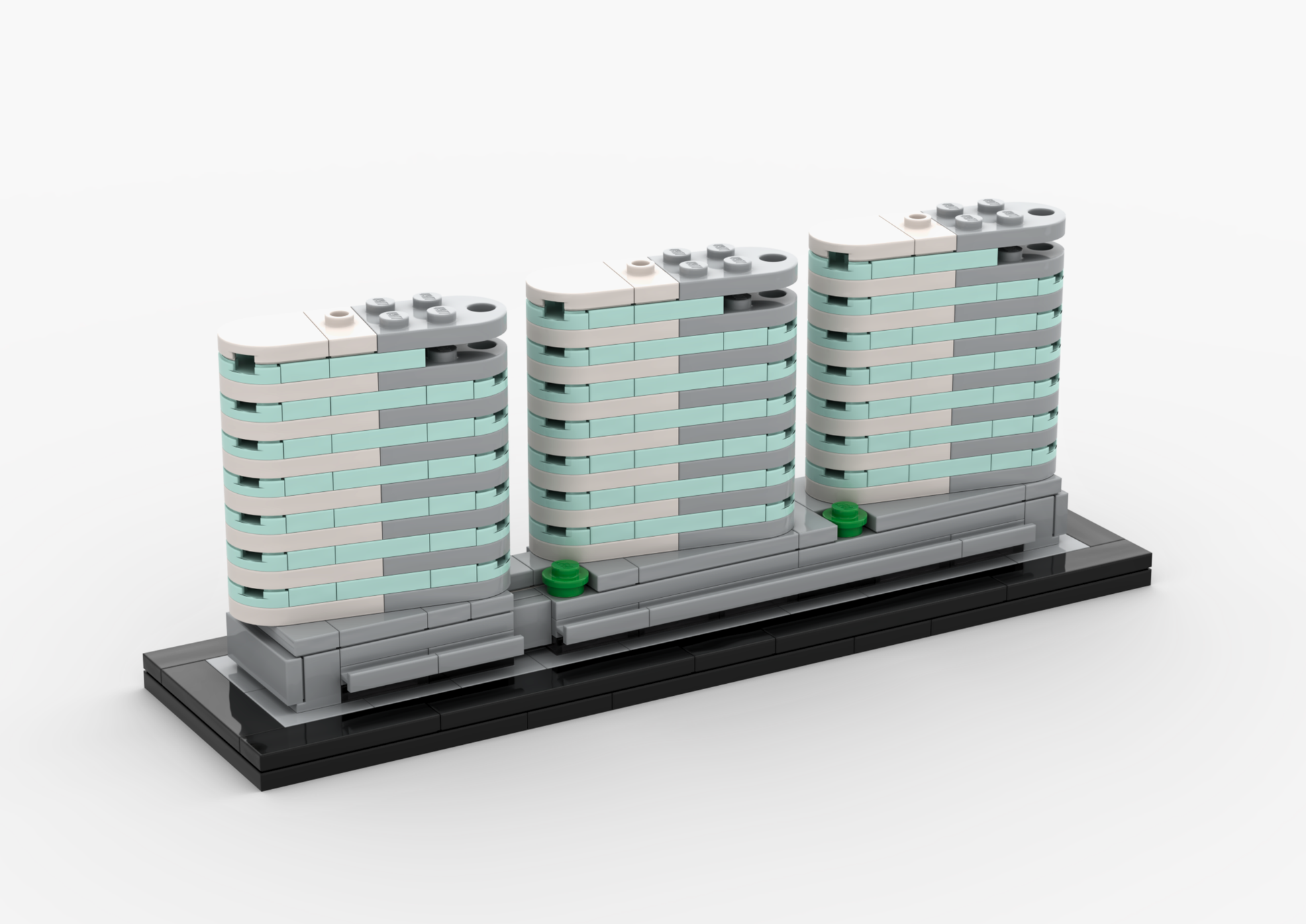 Model of three modern buildings made from interlocking bricks on a white background.