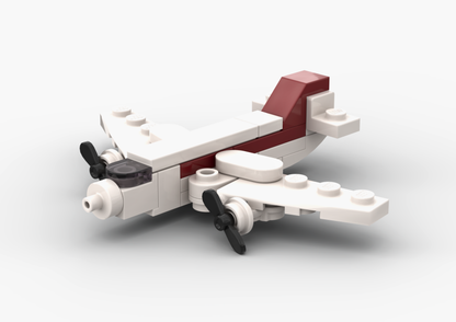 Small airplane model made of interlocking bricks on a white background.