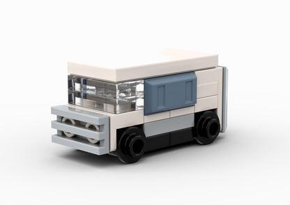 Small model of a truck made from interlocking bricks on a white background.