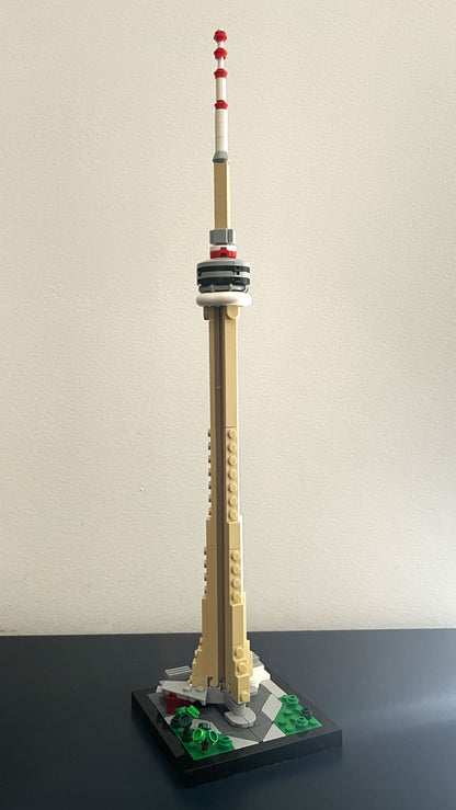 Model of a tower resembling the CN Tower made from building blocks on a plain background.