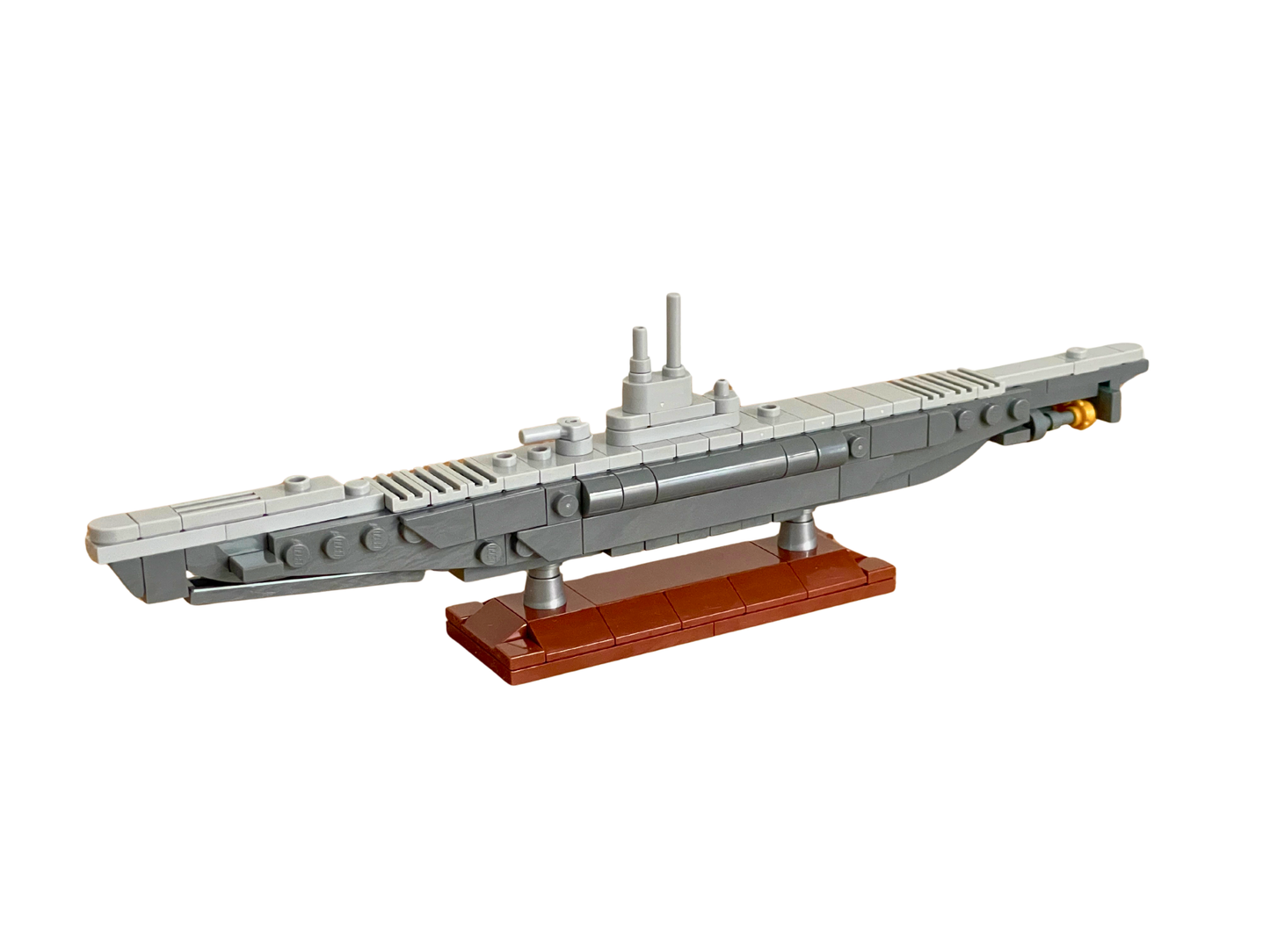 Model of a submarine made from building blocks on a white background