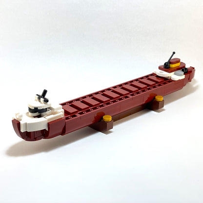 Model of a boat made from interlocking bricks on a white background.